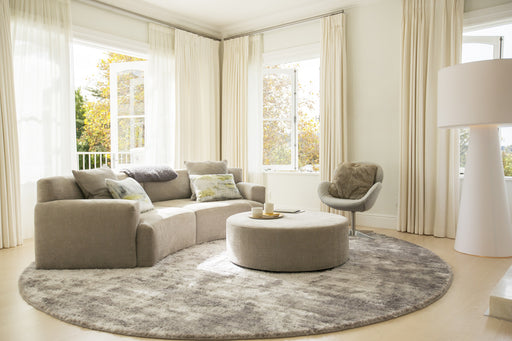 a light spacious living room with an ottoman