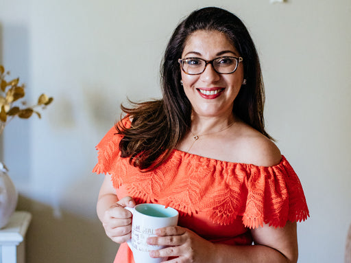 a lovely image of Nathalie in an orange embroidered top, smiling to the camera