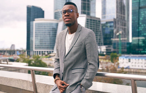 a man in a chic check black and white blazer