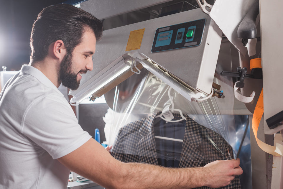 a man using a dry cleaning machine