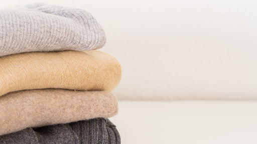 a pile of cashmere sweaters