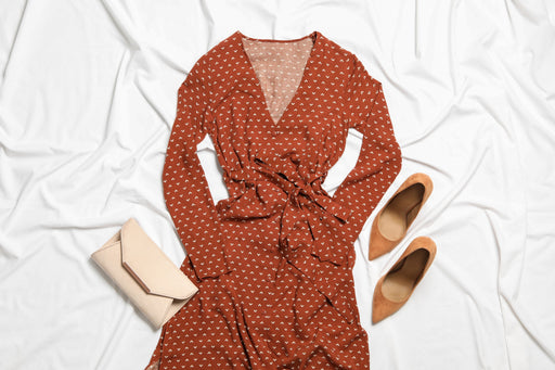 a rust coloured patterned dress teamed with tan pumps and purse