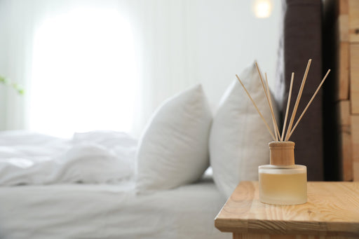 a scented diffuser on a nightstand