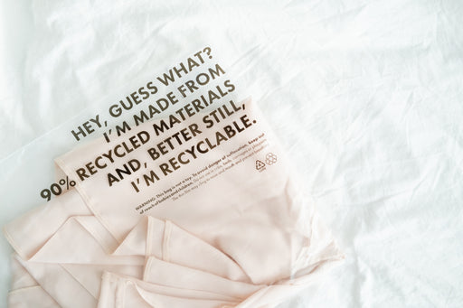 a shirt made of recycled materials packed in a recyclable bag