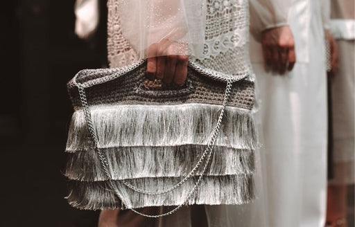a silver fringed handbag being modelled on the catwalk