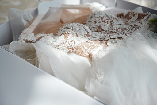 a stunning wedding dress being packed in a box