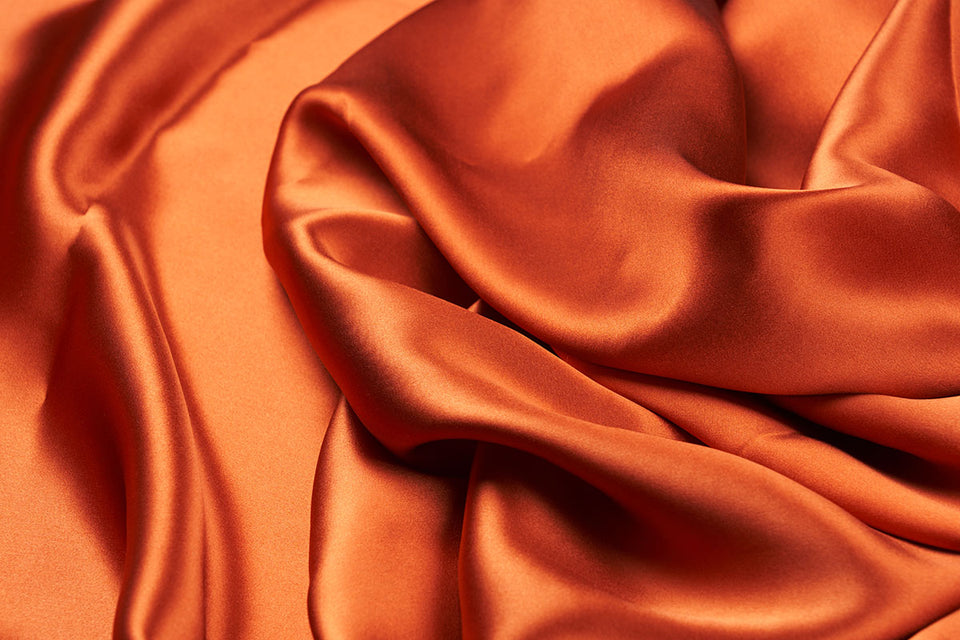 a swathe of luxurious rust colored silk
