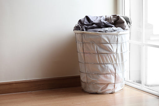 a wire frame laundry basket with a canvas interior lining 