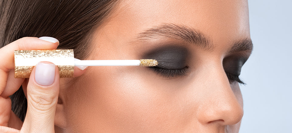 a woman having smokey eye makeup applied