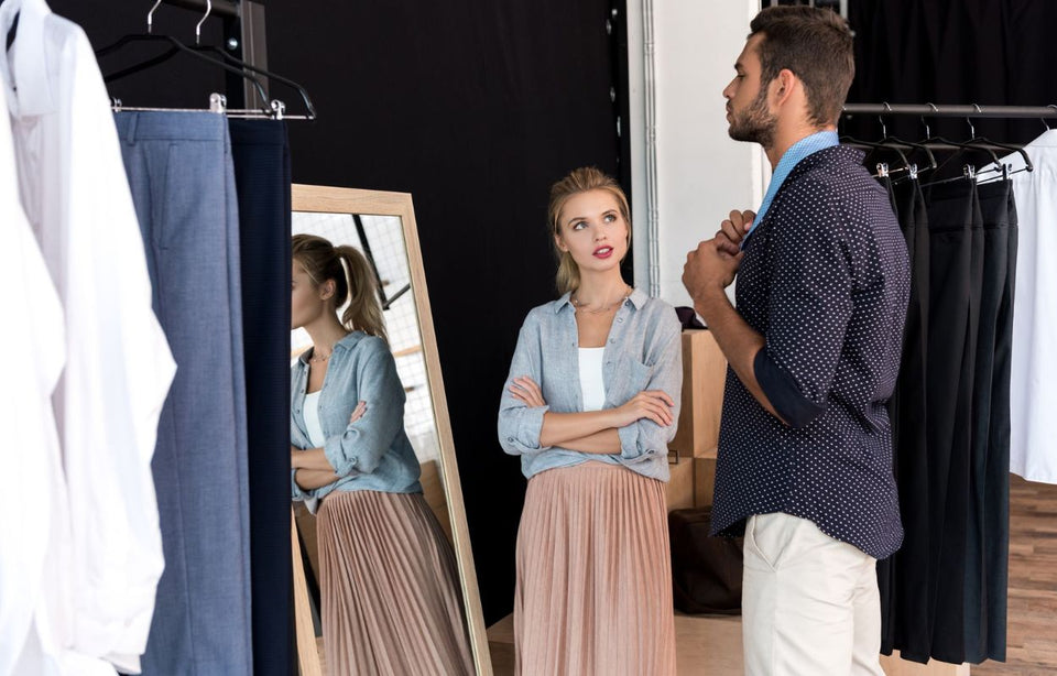 a woman helping her partner shop for new clothes