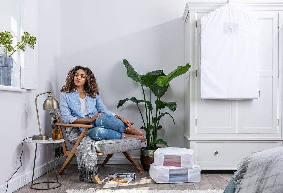 a woman sitting next to her Hayden Hill organic cotton storage and hanging bags