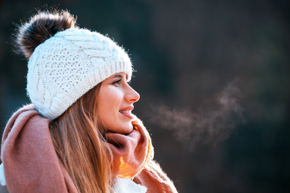 a woman wearing a cashmere scarf and woollen hat