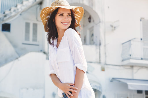 a woman wearing a floppy straw hat