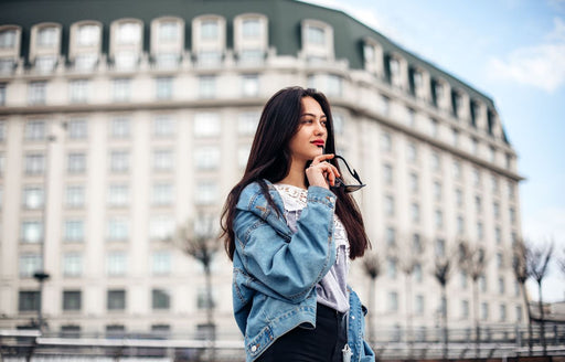 a woman wearing her large denim jacket off her shoulder