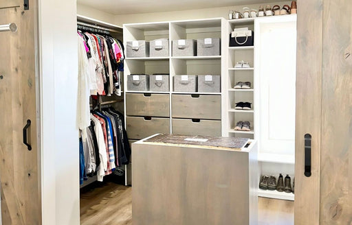 an interior view of a well organised walk-in master closet, arranged by Riquel’s company @R.Organize