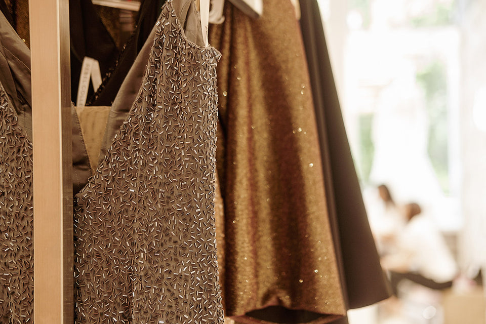 beaded and sparkly dresses hanging on a rail