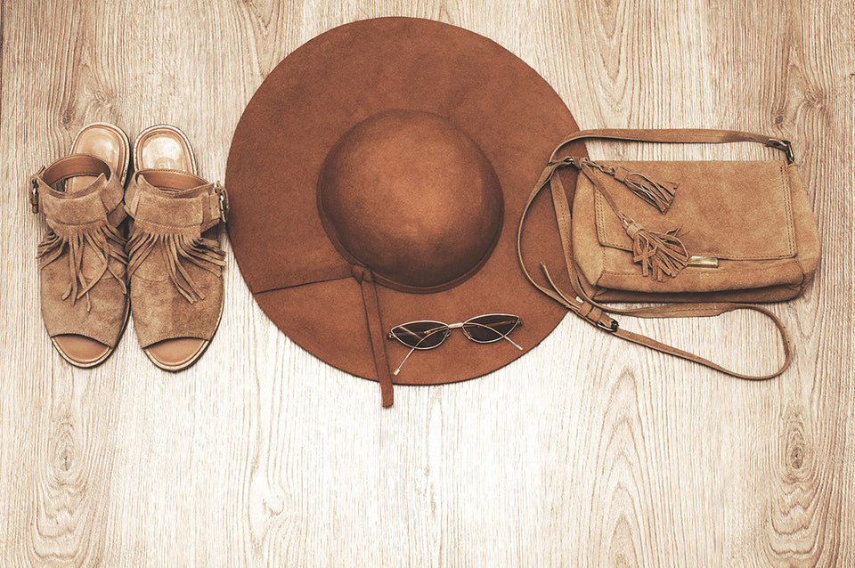 brown suede sandals with a matching purse, with a wide brimmed hat and sunglasses