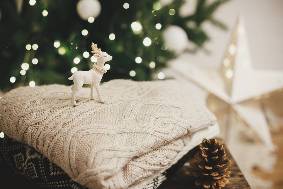 cosy knitted sweaters next to festive decorations