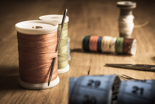 cotton reels and needles from a sewing kit