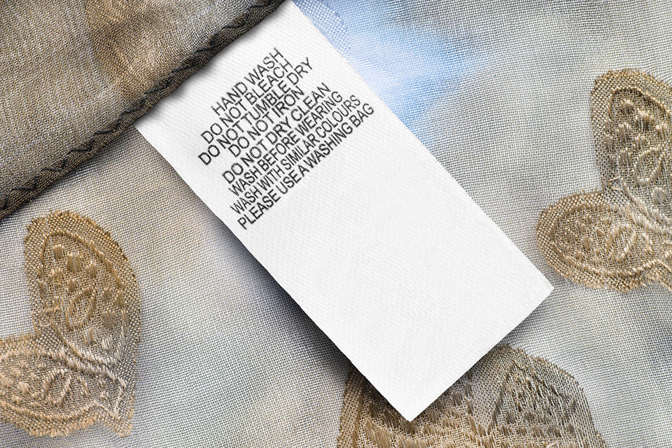 delicate embroidered fabric with hand wash instructions label