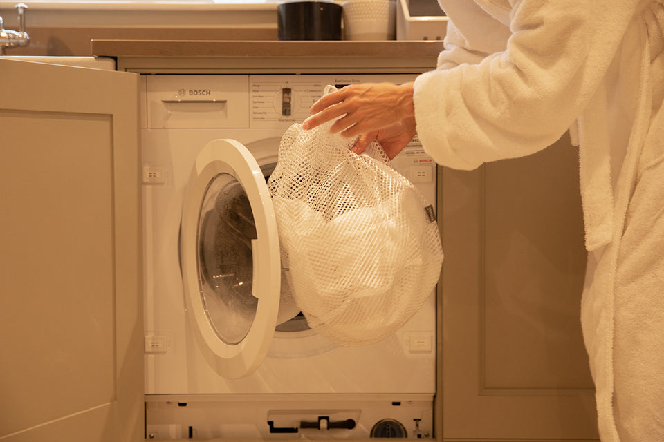 delicates in a mesh bag going in the washing machine