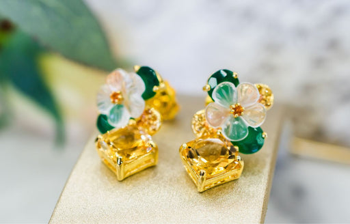 flower shaped earrings made with yellow and green sapphires