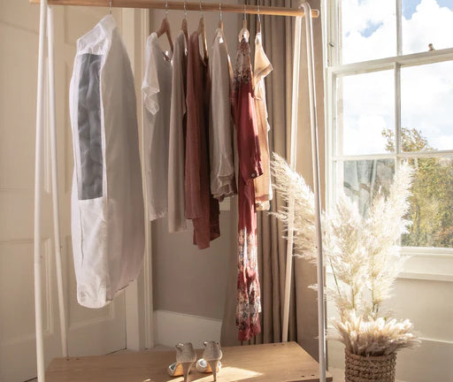 Organised clothes in a Hayden Hill organic cotton storage bag on a hanging rail