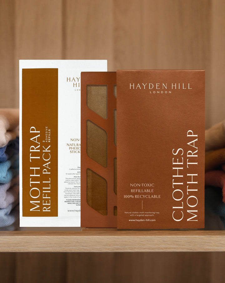 A Hayden Hill clothes moth trap and refill pack sitting side by side on a shelf