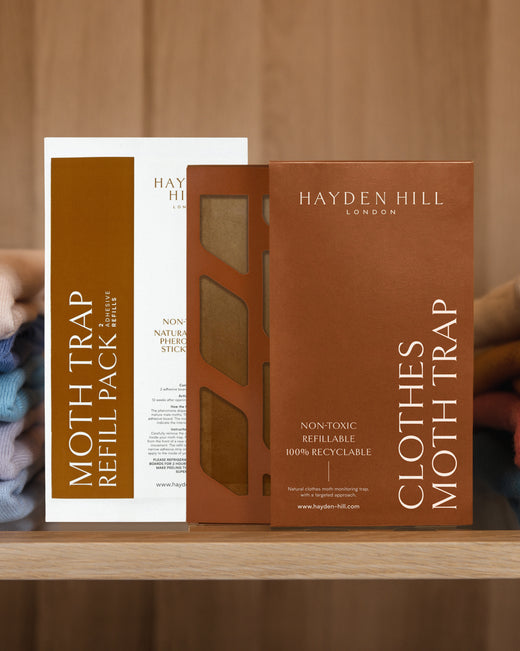 A Hayden Hill clothes moth trap and refill pack sitting side by side on a shelf