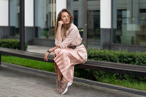 mixing a pleated silky pink skirt with a long pale pink blazer