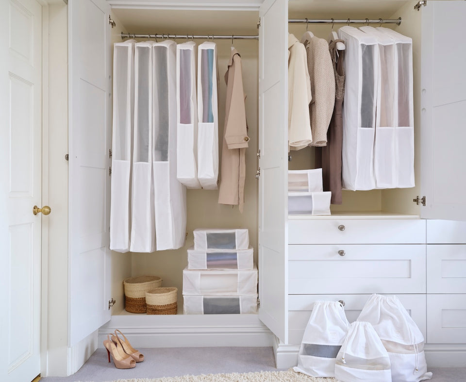 an open wardrobe filled with the Hayden Hill Complete Collection in White,comprising of Long and Short Hanging Bags, Large, Extra Large and Double Extra Large Storage Bags and Small, Medium and Large Dust Bags