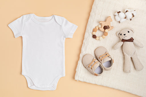 organic cotton baby grow with shoes and a teddy