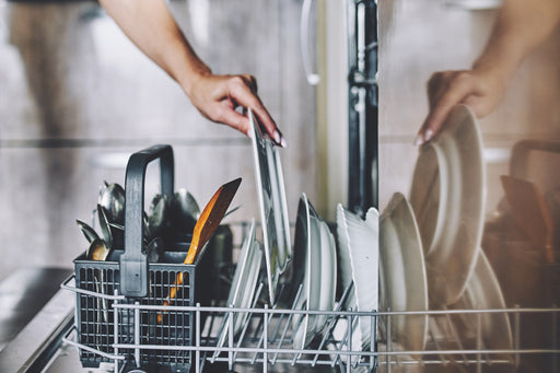 plates being loaded into a dishwasher