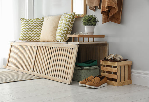 shoes stored under a storage bench