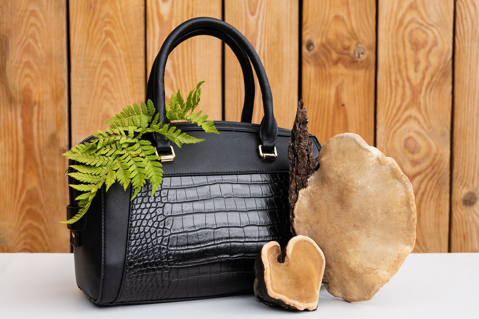 a stylish black handbag made from mushroom leather