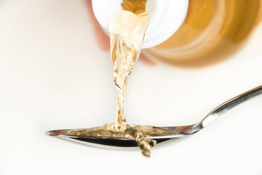 vinegar being poured onto a spoon