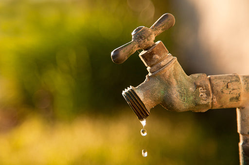 water droplets coming from an antique garden tap