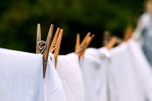 white laundry hanging on a washing line outdoors